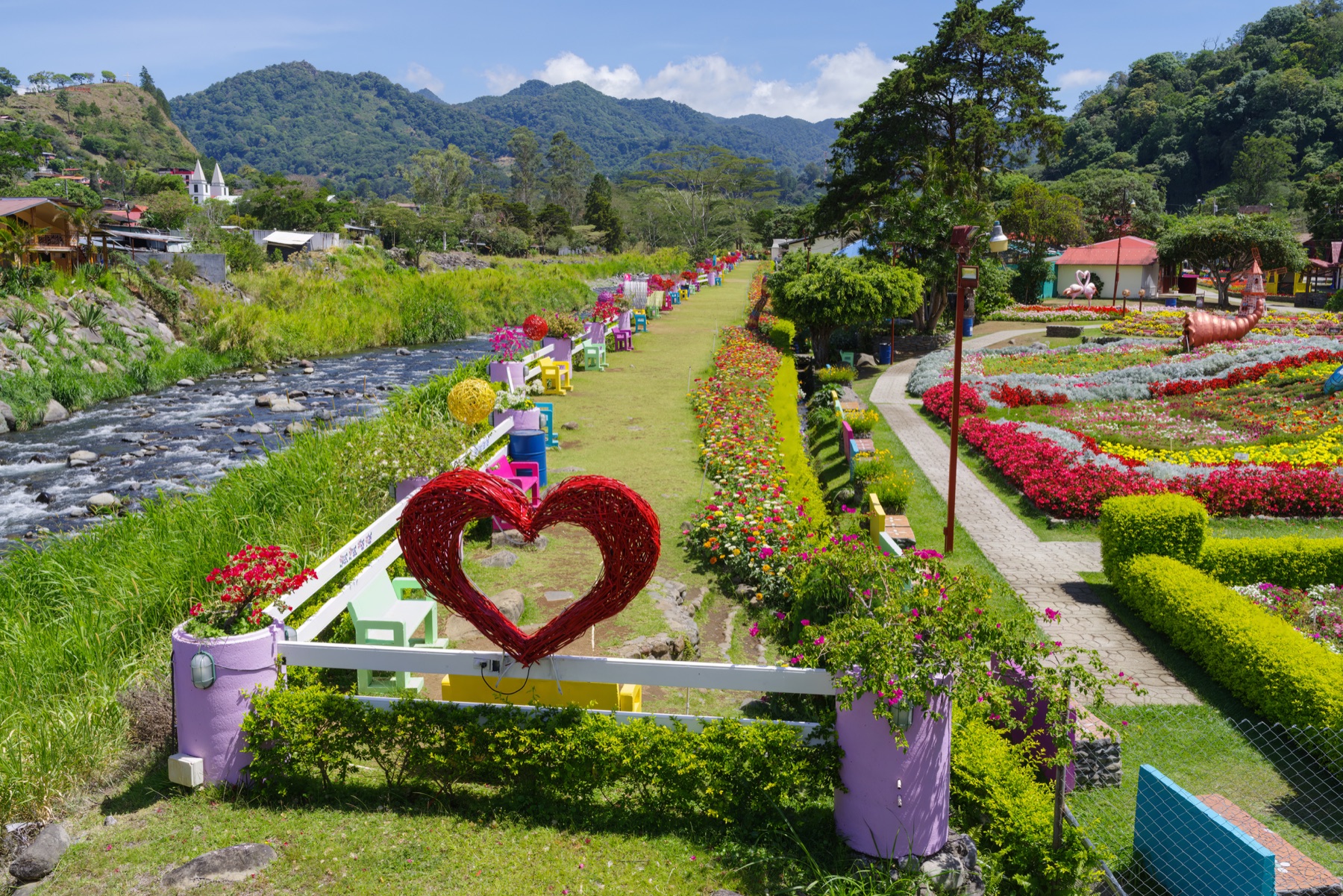 Boquete, Chiriquí, Panama, with river gardens, flowers, and green mountain ridges on a sunny day.