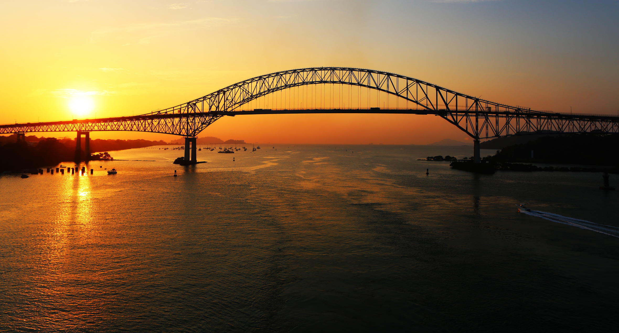 The Bridge of the Americas over the Panama Canal at sunset.